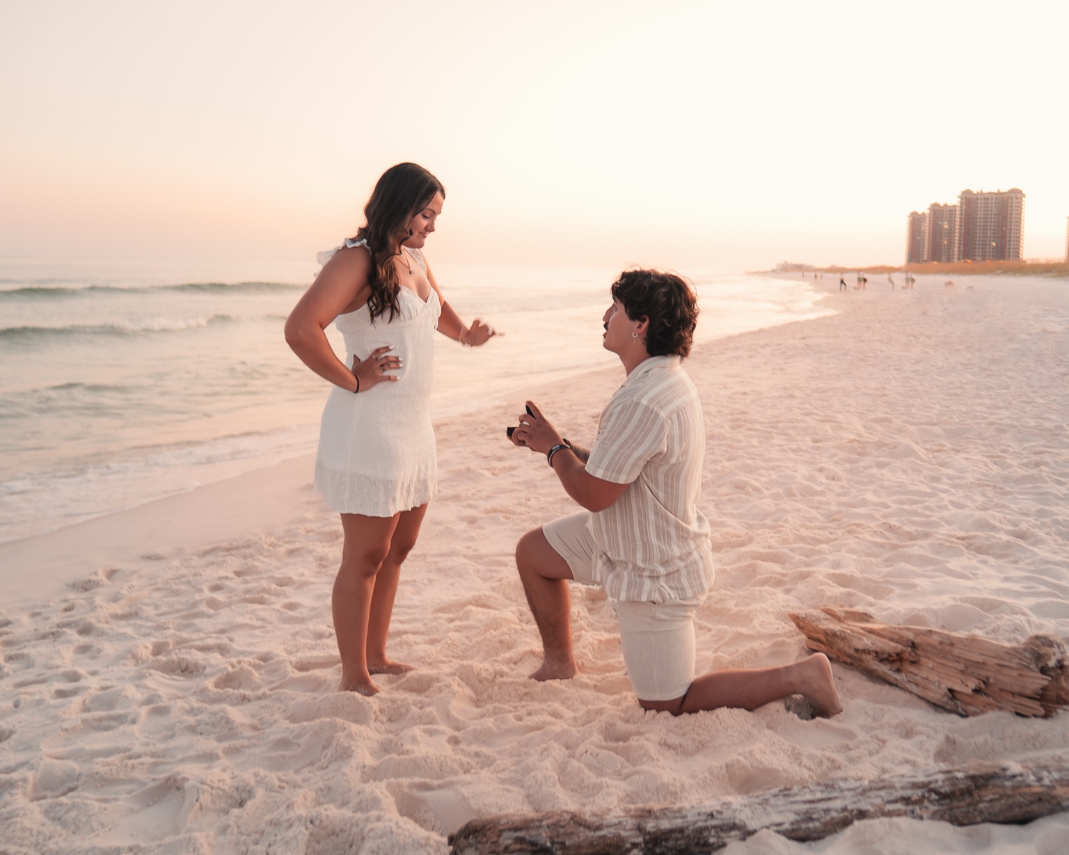 Sunset beach proposal beside the ocean
